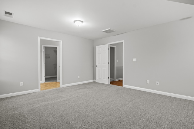 carpeted spare room featuring baseboards
