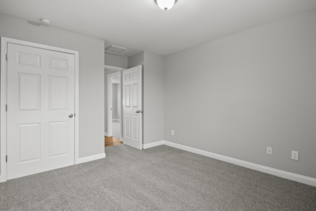 unfurnished bedroom with carpet flooring and baseboards