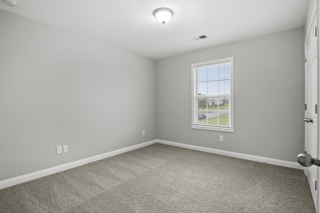 carpeted empty room with baseboards