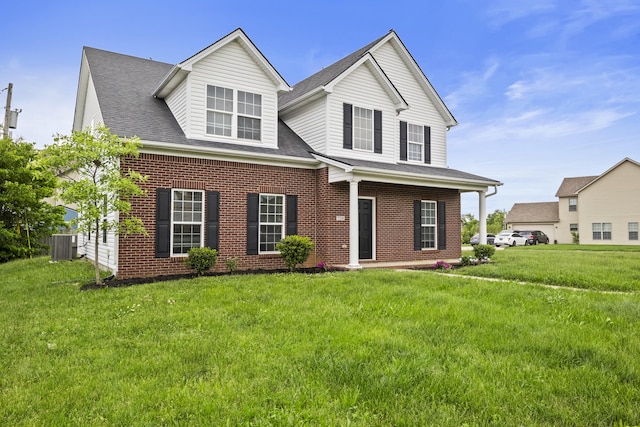 view of front facade featuring brick siding, a front yard, central air condition unit, and a shingled roof