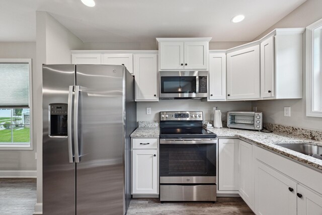 140 Peaceful Lndg, Georgetown, KY 40324 - kitchen with stainless steel appliances, wood finished floors, white cabinets, light stone counters, and recessed lighting