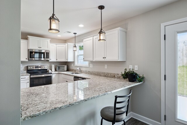 140 Peaceful Lndg, Georgetown, KY 40324 - kitchen featuring stainless steel appliances, a sink, white cabinets, light stone countertops, and decorative light fixtures
