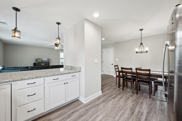 140 Peaceful Lndg, Georgetown, KY 40324 - kitchen featuring a ceiling fan, freestanding refrigerator, light wood-style floors, white cabinets, and light stone counters
