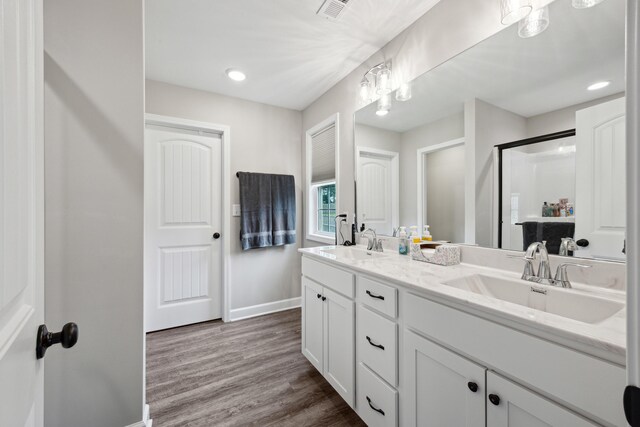 140 Peaceful Lndg, Georgetown, KY 40324 - bathroom with baseboards, a shower stall, wood finished floors, double vanity, and recessed lighting