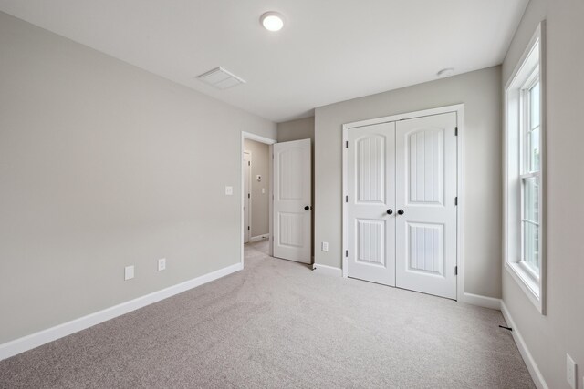 140 Peaceful Lndg, Georgetown, KY 40324 - unfurnished bedroom featuring light carpet, baseboards, and a closet
