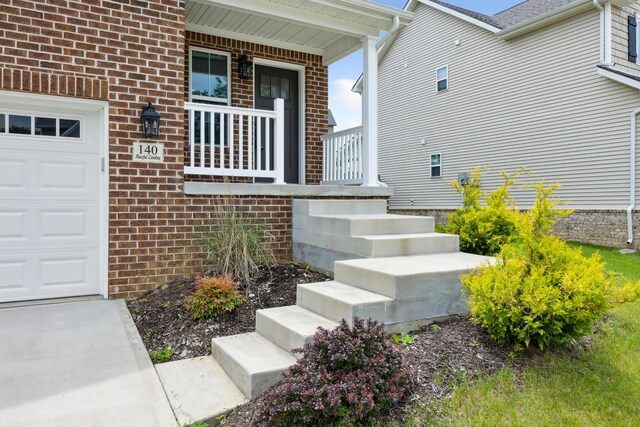 140 Peaceful Lndg, Georgetown, KY 40324 - doorway to property with a porch, brick siding, and an attached garage