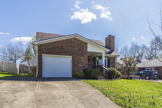 ranch-style home featuring brick siding, an attached garage, driveway, and a chimney