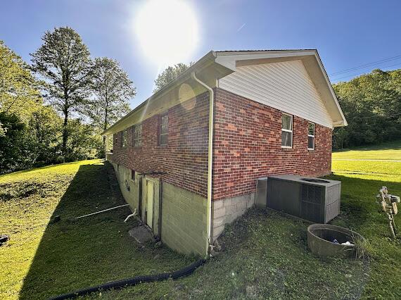 4216 N Ky 11, Cannon, KY 40923 - view of side of home with brick siding, central AC, and a lawn