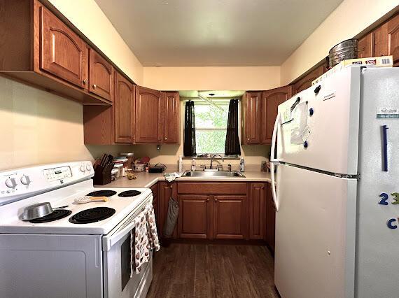 4216 N Ky 11, Cannon, KY 40923 - kitchen featuring white appliances, a sink, dark wood-style flooring, light countertops, and brown cabinetry
