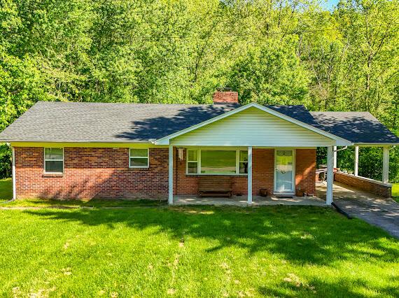 4216 N Ky 11, Cannon, KY 40923 - single story home with a chimney, a front yard, brick siding, and covered porch