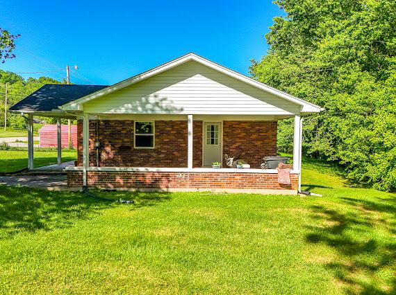 4216 N Ky 11, Cannon, KY 40923 - back of house with brick siding, a lawn, and a porch