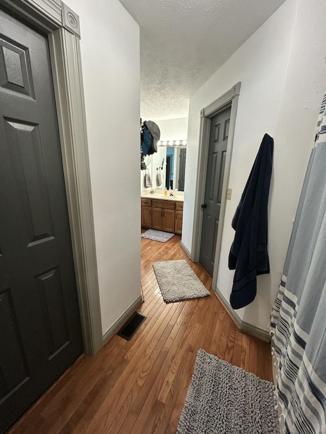 296 Ferry Rd, Somerset, KY 42503 - bathroom with a textured ceiling, wood finished floors, vanity, and baseboards