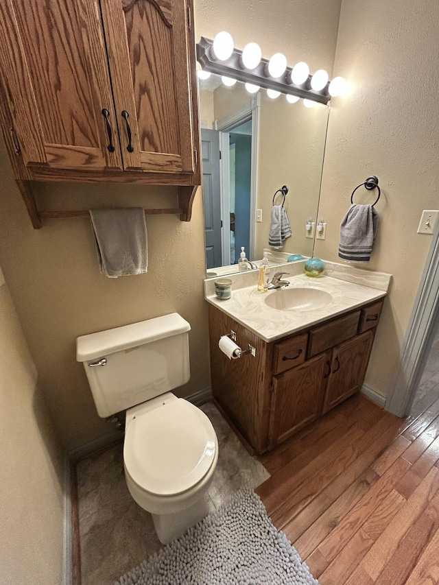 296 Ferry Rd, Somerset, KY 42503 - bathroom with wood finished floors, toilet, vanity, and baseboards