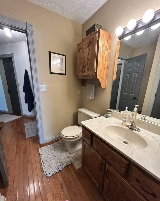 296 Ferry Rd, Somerset, KY 42503 - bathroom featuring hardwood / wood-style flooring, toilet, a textured ceiling, and vanity