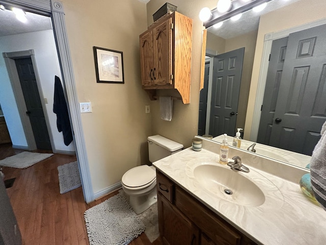 296 Ferry Rd, Somerset, KY 42503 - bathroom featuring wood finished floors, toilet, baseboards, and vanity