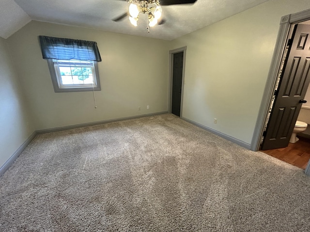 296 Ferry Rd, Somerset, KY 42503 - unfurnished bedroom with carpet flooring, baseboards, vaulted ceiling, ceiling fan, and connected bathroom