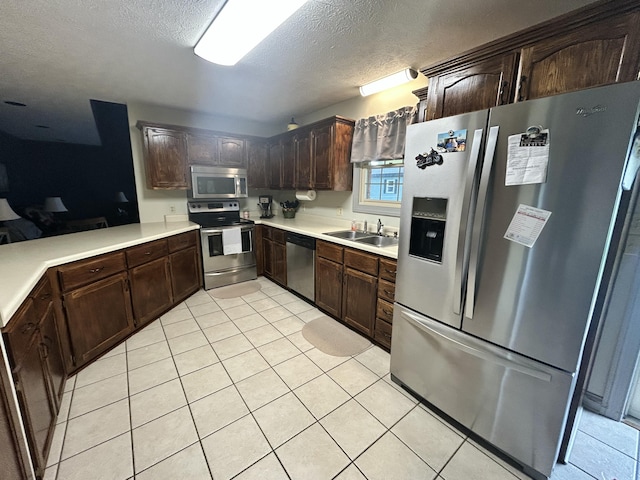 296 Ferry Rd, Somerset, KY 42503 - kitchen featuring stainless steel appliances, a sink, light tile patterned floors, light countertops, and dark brown cabinetry