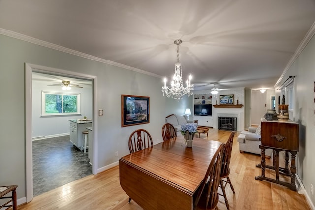445 Cecilian Ter, Danville, KY 40422 - dining space featuring ceiling fan, a fireplace, light wood-style flooring, a chandelier, and ornamental molding