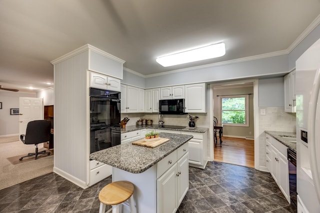445 Cecilian Ter, Danville, KY 40422 - kitchen featuring black appliances, a center island, light stone countertops, white cabinets, and ornamental molding