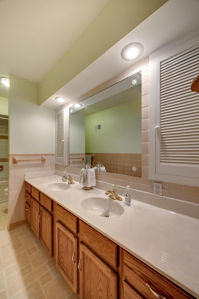 445 Cecilian Ter, Danville, KY 40422 - bathroom featuring tile walls, double vanity, and a wainscoted wall