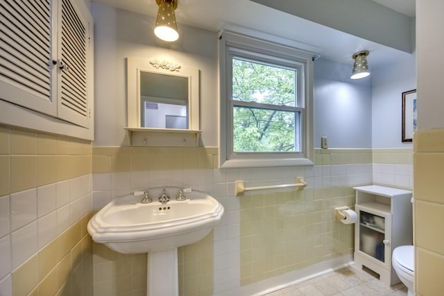 445 Cecilian Ter, Danville, KY 40422 - bathroom featuring tile walls, toilet, a wainscoted wall, and tile patterned floors