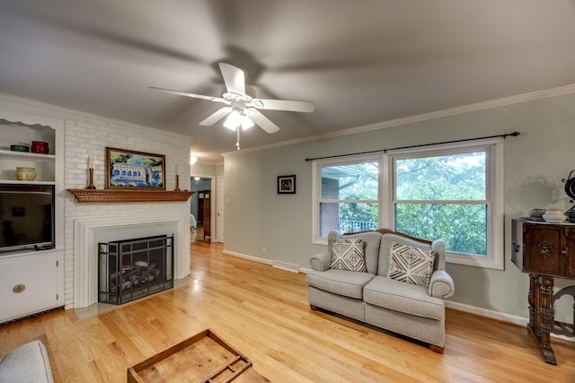 445 Cecilian Ter, Danville, KY 40422 - living area with crown molding, ceiling fan, light wood-style flooring, a large fireplace, and baseboards