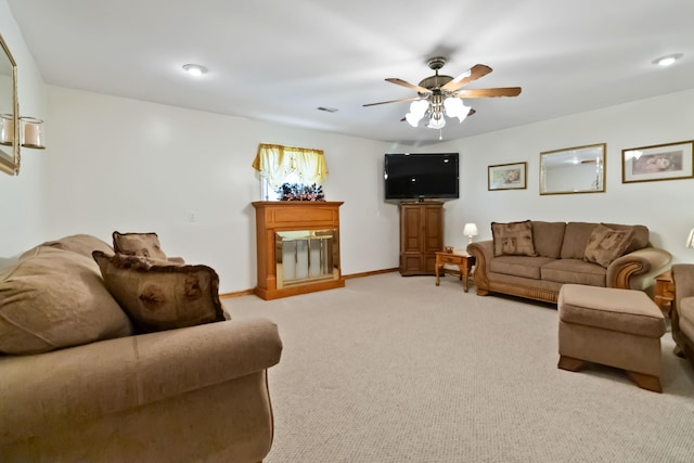 240 Percheron Dr, Richmond, KY 40475 - living room featuring a glass covered fireplace, ceiling fan, light carpet, and baseboards