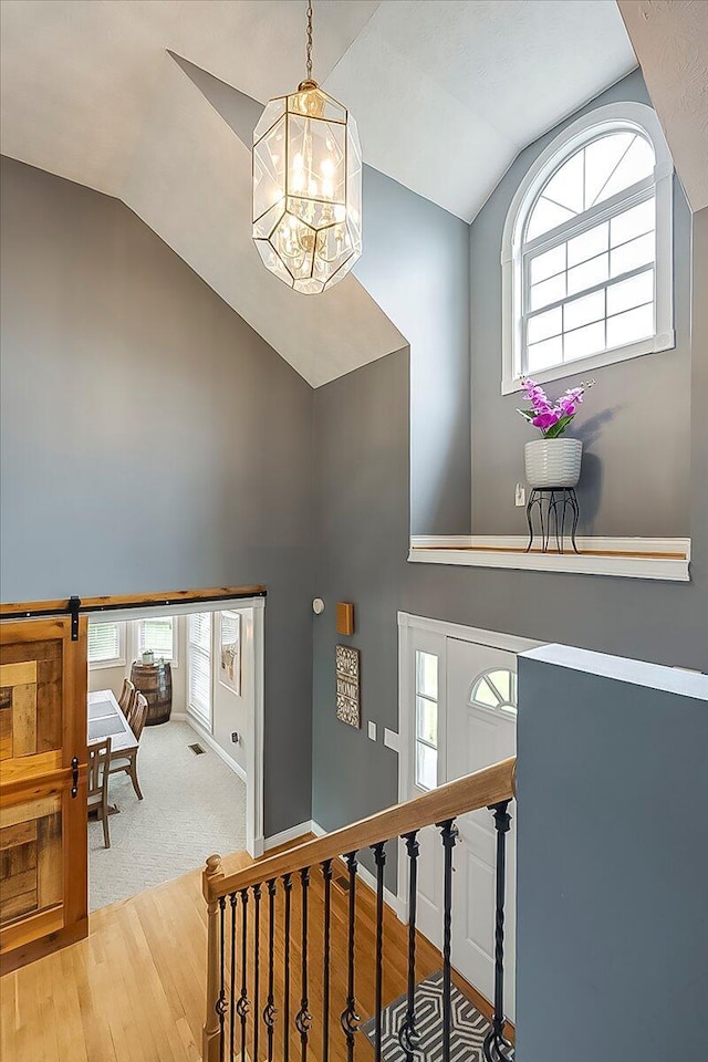 835 Isaac Shelby Cir, Frankfort, KY 40601 - stairway with a chandelier, wood finished floors, high vaulted ceiling, and baseboards