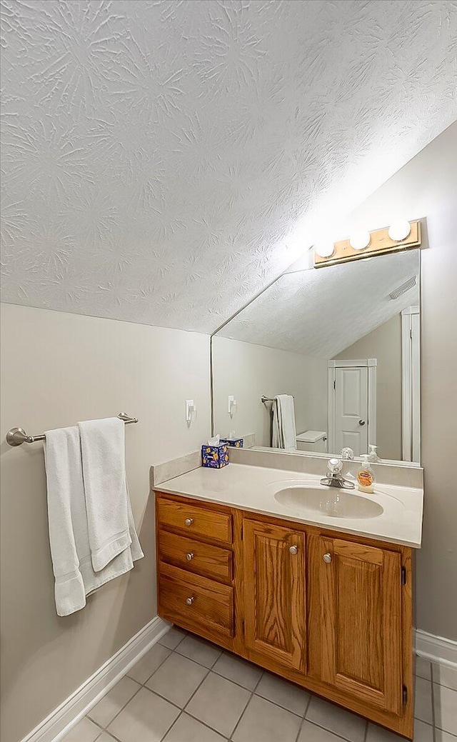 835 Isaac Shelby Cir, Frankfort, KY 40601 - bathroom featuring tile patterned flooring, lofted ceiling, vanity, a textured ceiling, and baseboards
