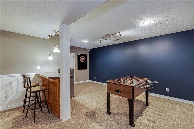 835 Isaac Shelby Cir, Frankfort, KY 40601 - rec room with light colored carpet, a bar, and baseboards