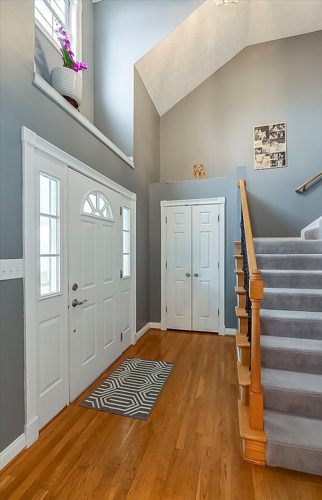 835 Isaac Shelby Cir, Frankfort, KY 40601 - foyer entrance with high vaulted ceiling, stairs, hardwood / wood-style flooring, and baseboards