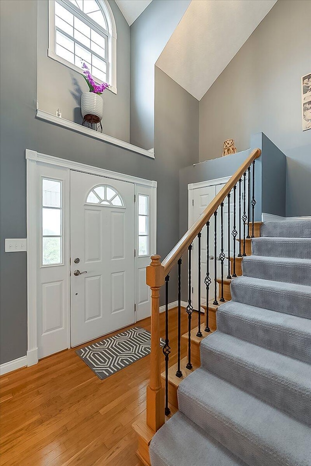 835 Isaac Shelby Cir, Frankfort, KY 40601 - entrance foyer with high vaulted ceiling, wood finished floors, baseboards, and stairs