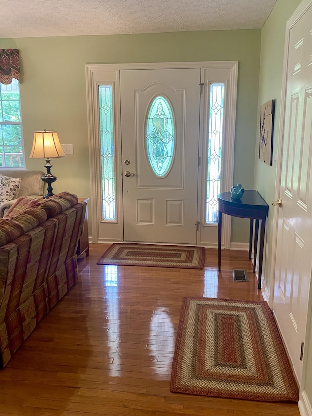 45 Rons Pond Rd, Corbin, KY 40701 - foyer entrance featuring wood finished floors, plenty of natural light, baseboards, and a textured ceiling