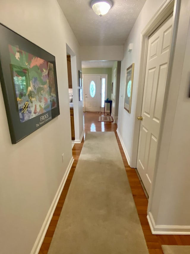 45 Rons Pond Rd, Corbin, KY 40701 - hall with dark wood-style floors, a textured ceiling, and baseboards