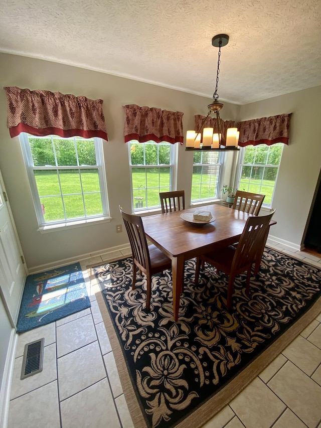 45 Rons Pond Rd, Corbin, KY 40701 - dining area featuring light tile patterned floors, a textured ceiling, a chandelier, and baseboards