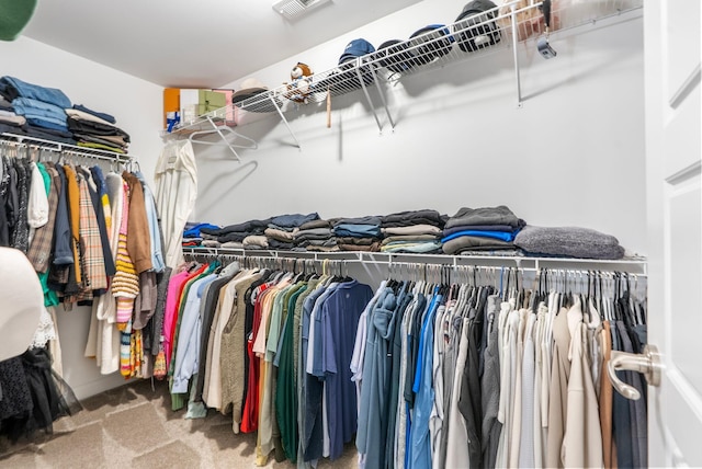 walk in closet featuring carpet flooring