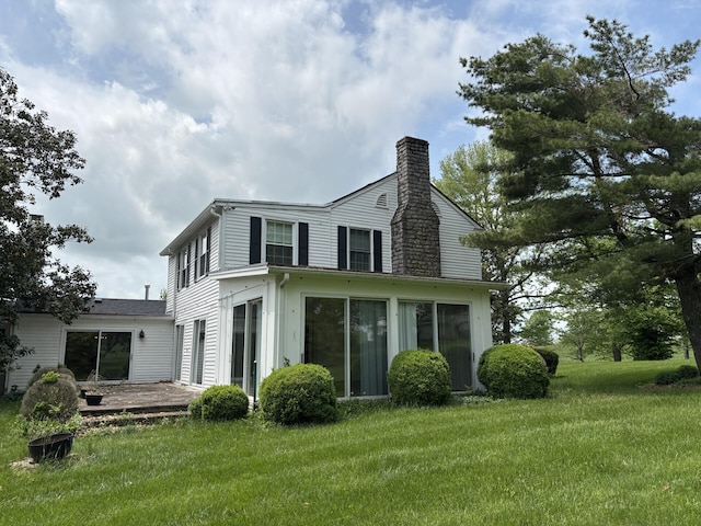 1439 Stanford St, Lancaster, KY 40444 - back of house with a chimney, a yard, a patio, and a sunroom