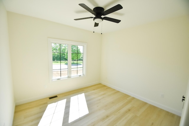 empty room with light wood-style flooring, baseboards, and ceiling fan