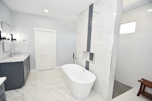 full bath with vanity, marble finish floors, a freestanding bath, a walk in shower, and recessed lighting