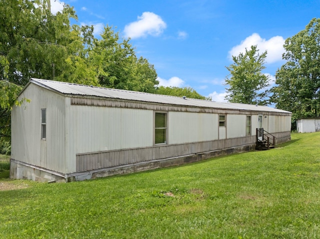 3145 Lily Rd, London, KY 40744 - view of home's exterior with entry steps, a yard, and metal roof