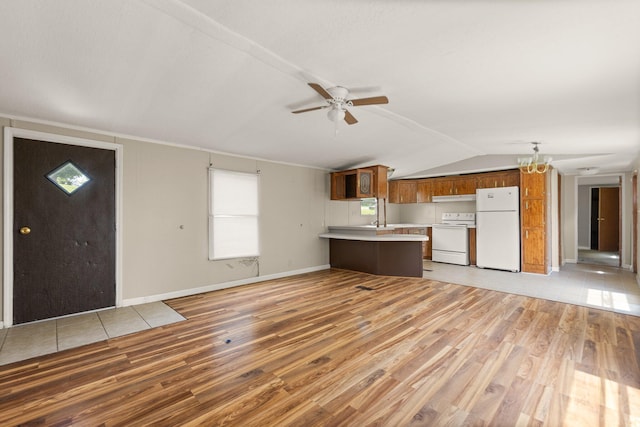 3145 Lily Rd, London, KY 40744 - kitchen with white appliances, a peninsula, light countertops, light wood-type flooring, and brown cabinetry