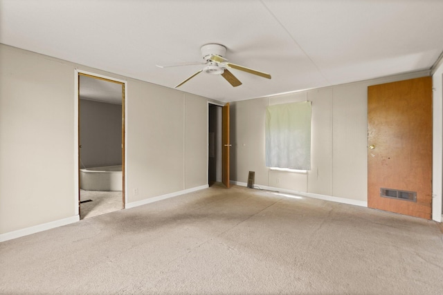 3145 Lily Rd, London, KY 40744 - unfurnished bedroom with carpet flooring, ceiling fan, ensuite bathroom, and baseboards