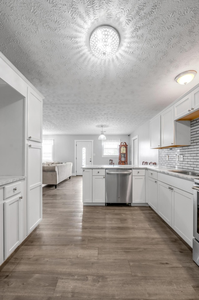 524 Joel St, Lexington, KY 40508 - kitchen with stainless steel dishwasher, a textured ceiling, healthy amount of natural light, a peninsula, and white cabinets