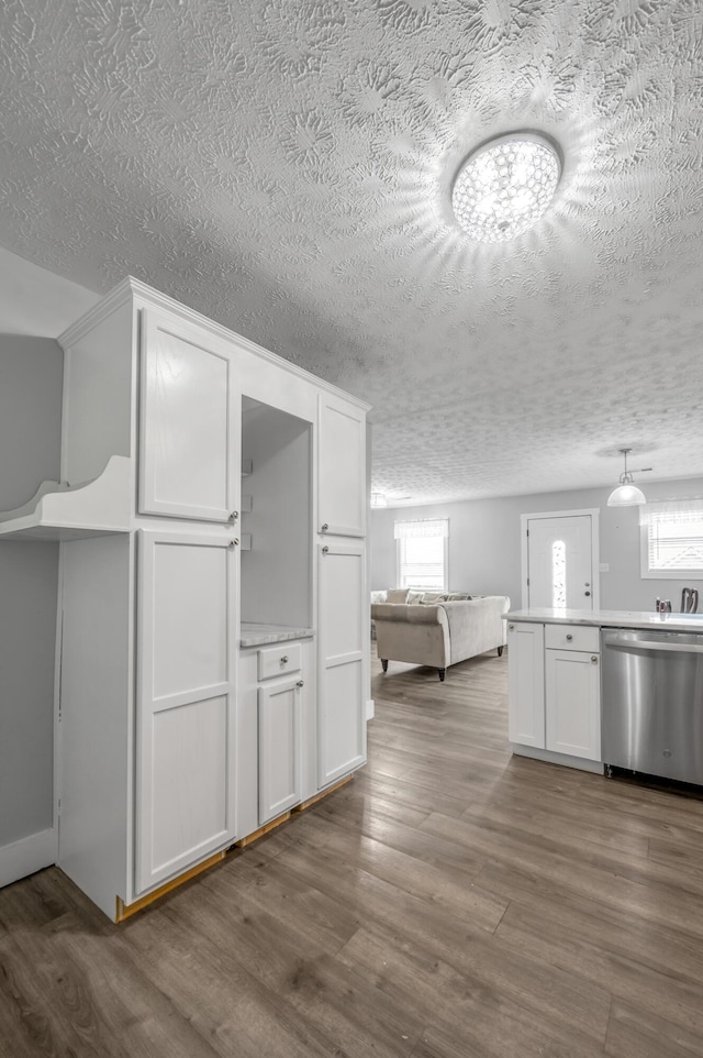 524 Joel St, Lexington, KY 40508 - kitchen featuring stainless steel dishwasher, a textured ceiling, plenty of natural light, and white cabinetry