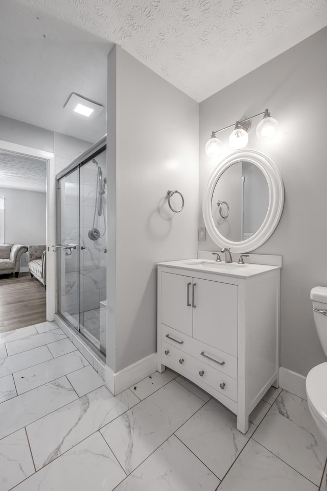524 Joel St, Lexington, KY 40508 - ensuite bathroom with marble look tiles, vanity, a shower stall, and a textured ceiling