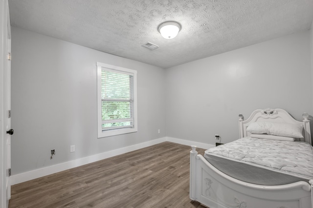 524 Joel St, Lexington, KY 40508 - bedroom with wood finished floors and a textured ceiling