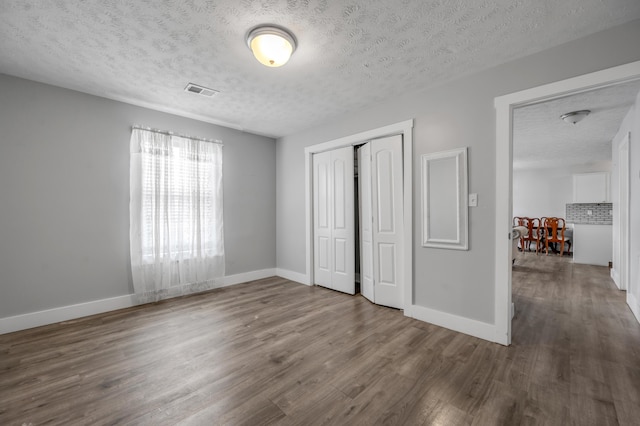 524 Joel St, Lexington, KY 40508 - unfurnished bedroom with wood finished floors, a textured ceiling, and a closet