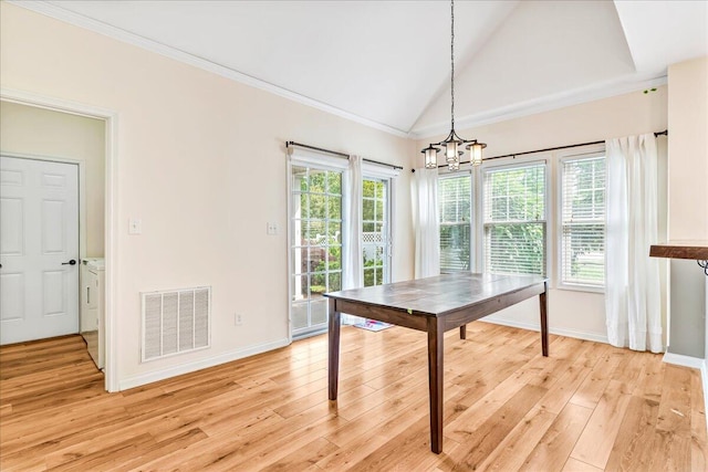 dining area with a chandelier, light wood-type flooring, vaulted ceiling, baseboards, and crown molding