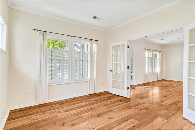 entryway with french doors, wood finished floors, ornamental molding, and baseboards