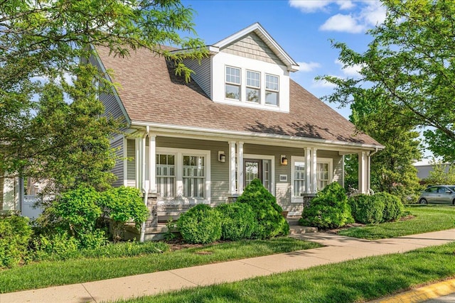 view of front of home with covered porch and a shingled roof